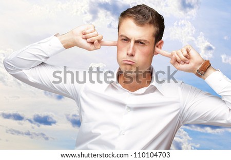 Portrait Of Young Man With Finger In His Ear, Outdoor