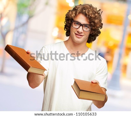 Portrait Of A Young Student Holding Books, Outdoor