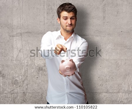 A Businessman Putting A Coin Into A Pink Piggy Bank, Indoor