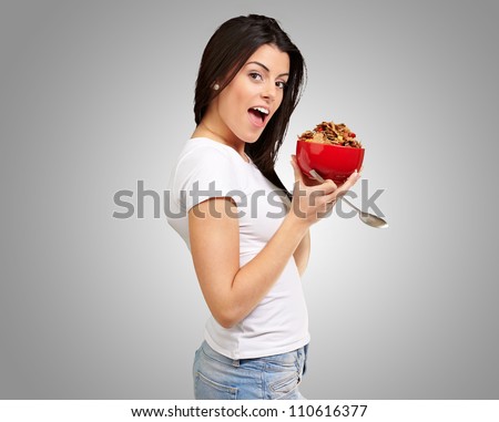 Young Girl Holding Cornflakes Isolated On Grey