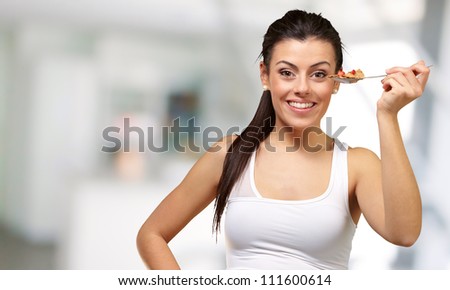 Young girl showing spoon full of cornflakes, indoor