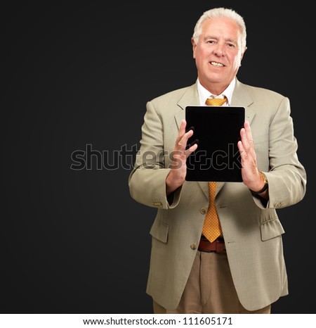Senior Man Holding A Touch pad On A Black Background