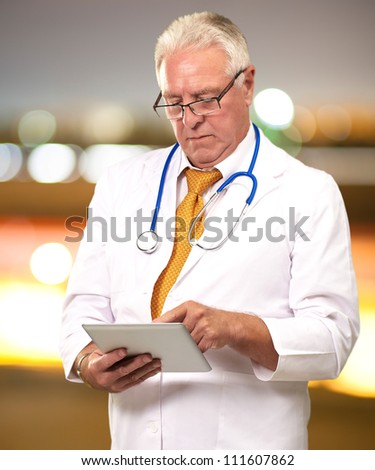 Portrait Of A Male Doctor Holding A Tab, Background