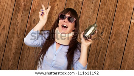 Woman Wearing Neck brace Holding A Shaker, Indoor