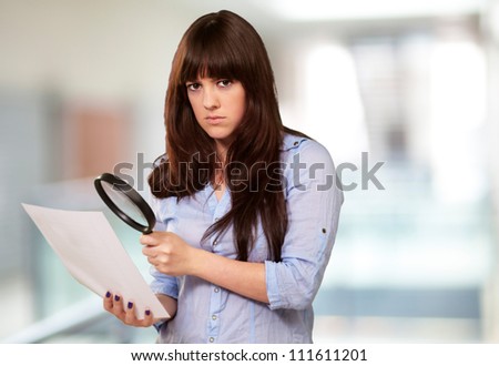 Portrait Of A Girl Holding A Magnifying Glass And Paper, Indoor