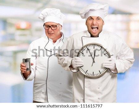 Portrait Of Angry Chef Holding Clock, Indoor