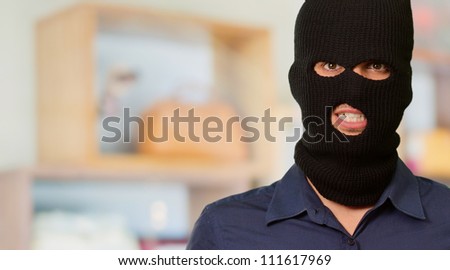 Portrait of a man wearing mask holding a flag, indoor