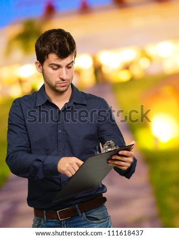 Young Man Holding Clipboard, Outdoor
