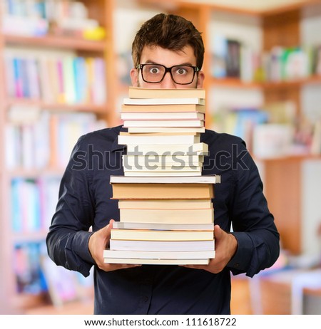 Young Man Holding Books, Indoor