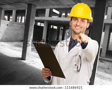 Technician Holding Clipboard At Construction Site