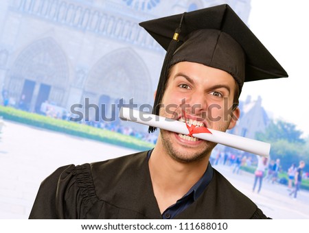 Man With Graduation Certificate In Mouth, Outdoor