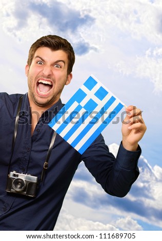 Man holding flag and miniature airplane, outdoor