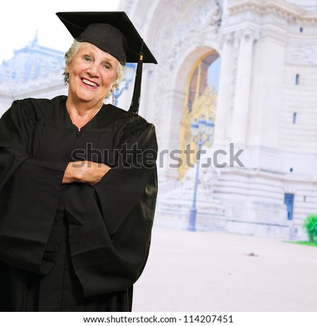 Senior Woman In Graduate Gown, Outdoors
