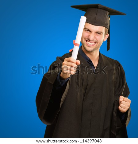 Graduate Man Holding Degree Isolated On Blue Background - stock photo