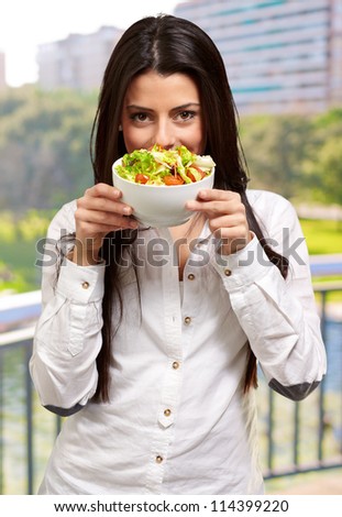 Young Girl Showing A Bowl Of Salad, outdoor