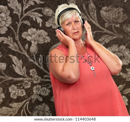 Portrait Of A Senior Woman With Headphone On Wallpaper