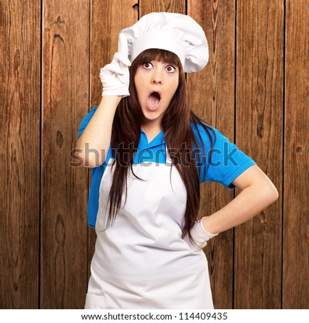 portrait of female chef shocked, indoor