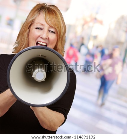 Woman screaming on a megaphone, outdoor