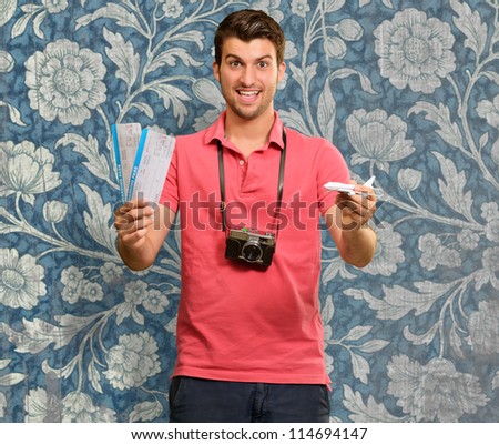 Man holding boarding pass and airplane, wallpaper