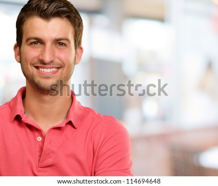 Portrait of young man smiling, background