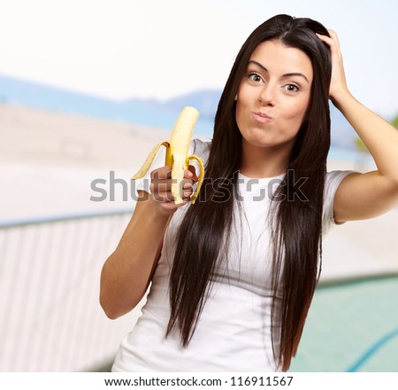 A Young Woman Eating A Banana, Outdoor