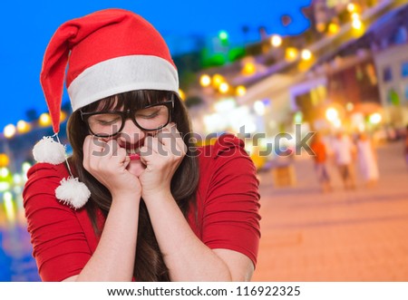 excited christmas woman with her eyes shut, outdoor