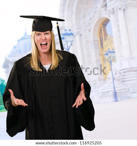 Angry Graduate Woman in front of an old building, outdoor