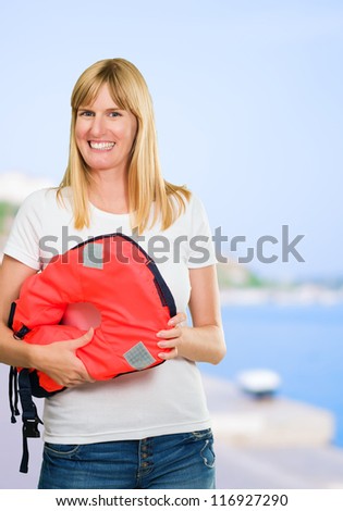 Happy Woman Holding Life Jacket, outdoor