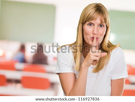 Woman With Finger On Lip at a classroom