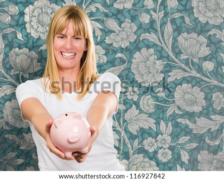 Woman Holding Piggy bank against a vintage floral background