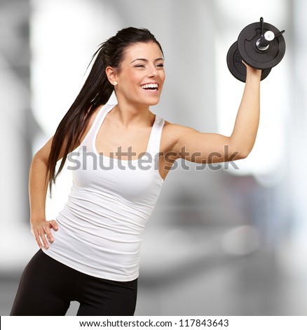 portrait of young girl training with weights indoor