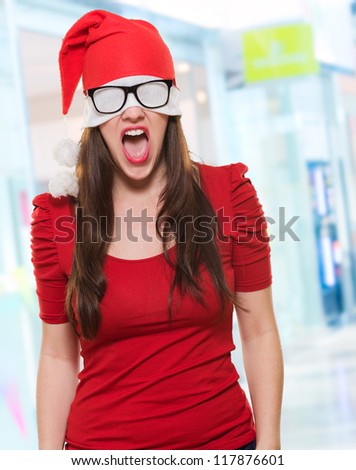 angry christmas woman with a hat and glasses covering her eyes, indoor