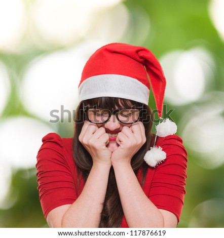 excited christmas woman with her eyes shut against a nature background