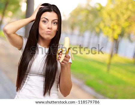 A Young Woman Eating A Banana, Outdoor