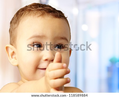 Portrait Of Baby Boy Extending Hand, indoor