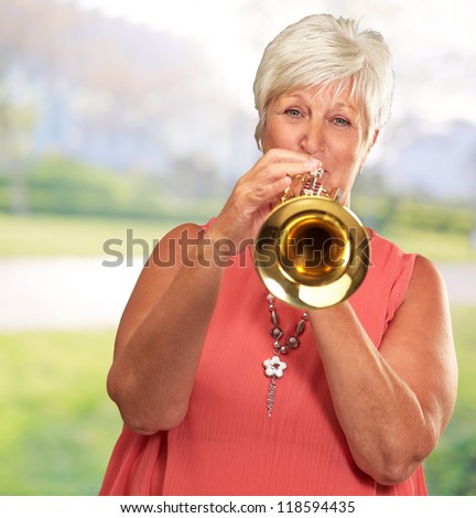 Mature Woman Blowing Her Trumpet, Outdoor