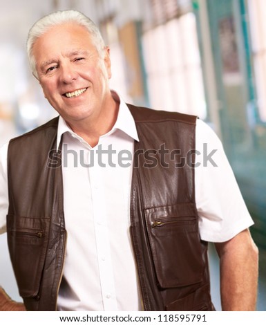 Senior Man Standing With Hand On Hips, Indoor