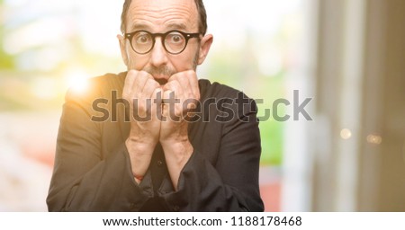 Priest religion man terrified and nervous expressing anxiety and panic gesture, overwhelmed