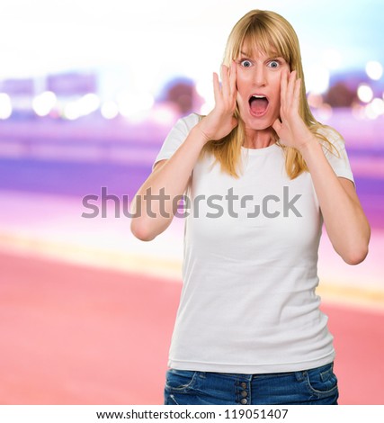 Portrait Of Shocked Woman against a city by night