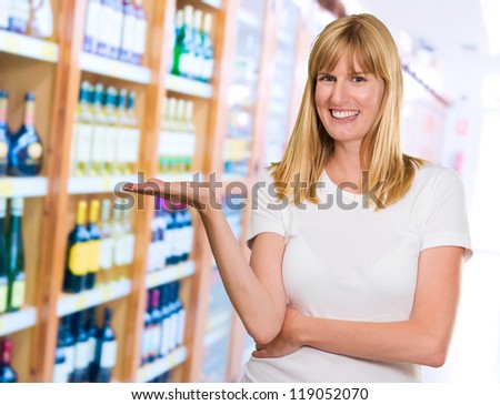 Happy Woman Presenting at a wine store