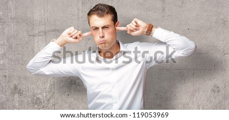 Portrait Of Young Man With Finger In His Ear, Indoor