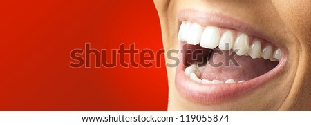Close Up Of Smiling Teeth against a red background