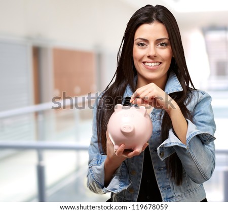 Portrait Of A Female Holding A Coin And Piggy bank, Indoor