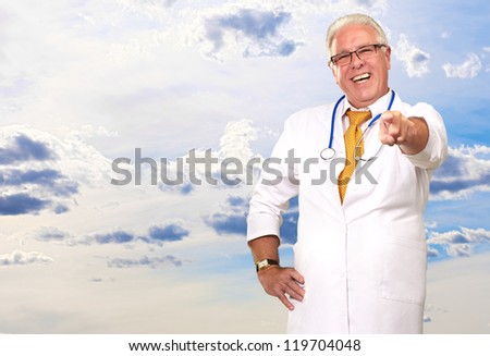 Portrait Of A Senior Doctor Pointing, Outdoor