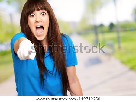 woman screaming and pointing finger, outdoor