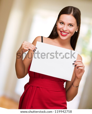 Beautiful woman holding a blank placard, indoor