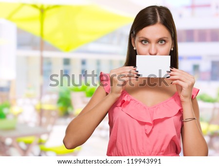 Woman Covering Her Mouth With Blank Placard, outdoor