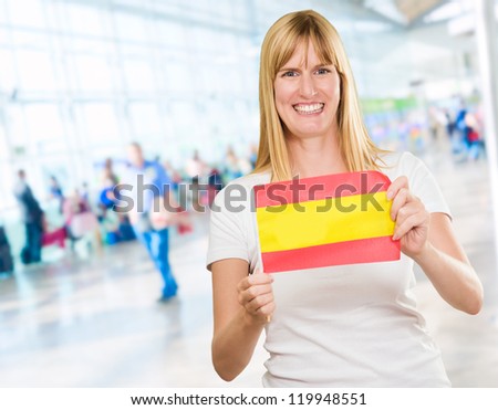 Happy Woman Holding Spanish Flag, indoor
