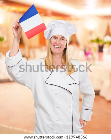Happy Chef Holding French Flag at a restaurant