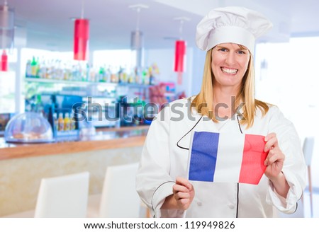 Happy Chef Holding French Flag at a bar, indoor